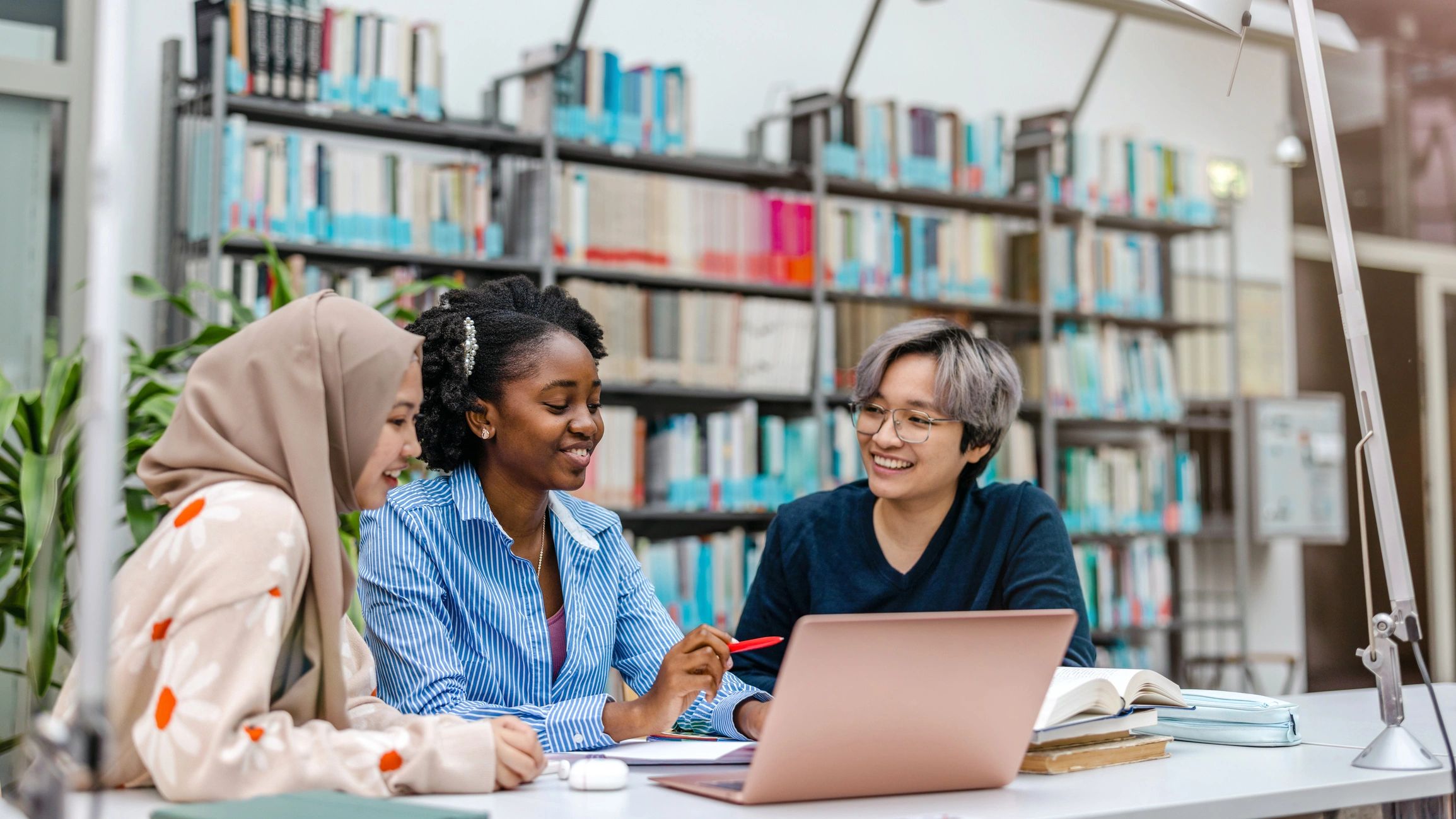 Group of students studying together in a library