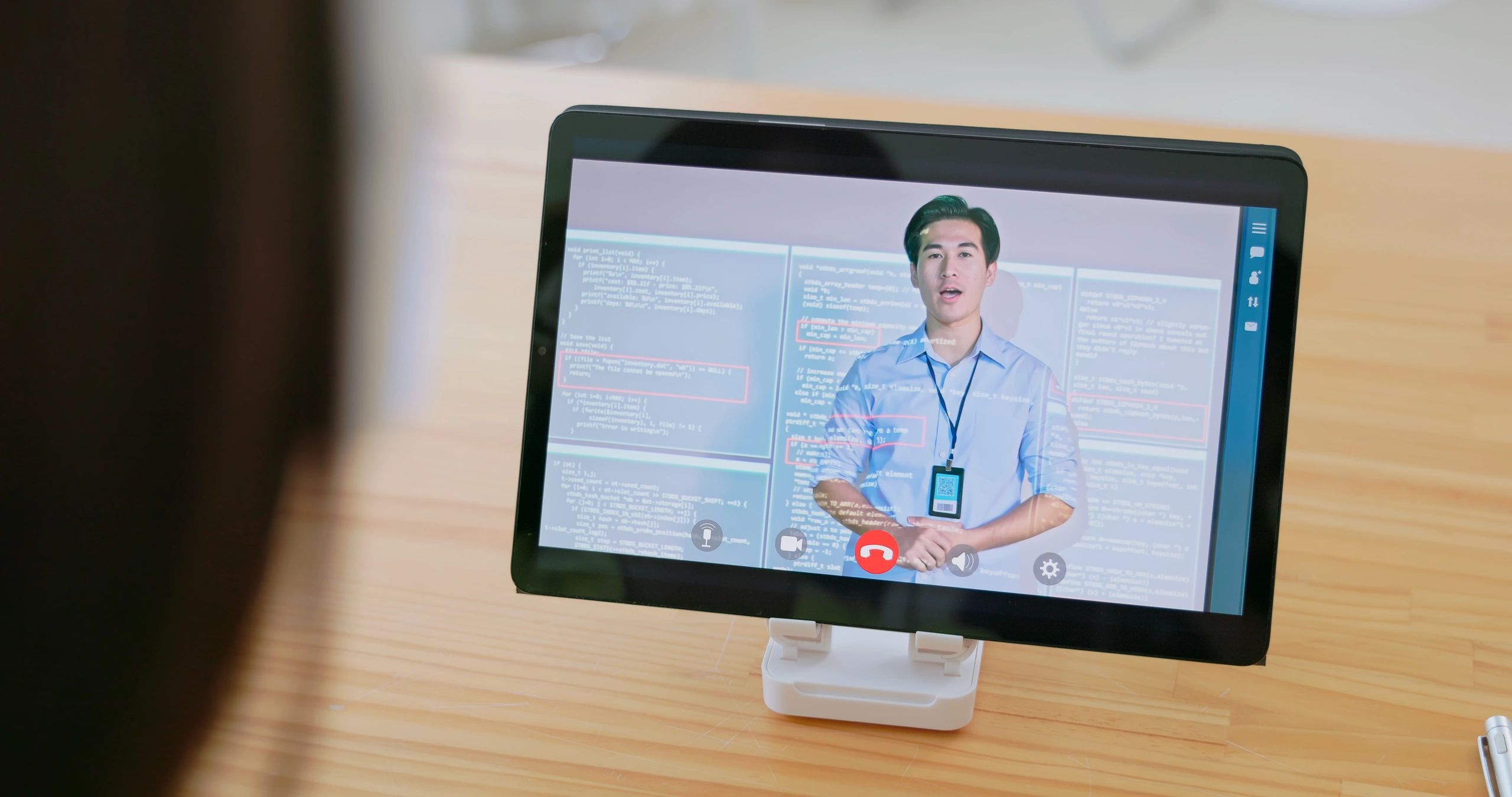 Student watching an online programming lesson on a tablet